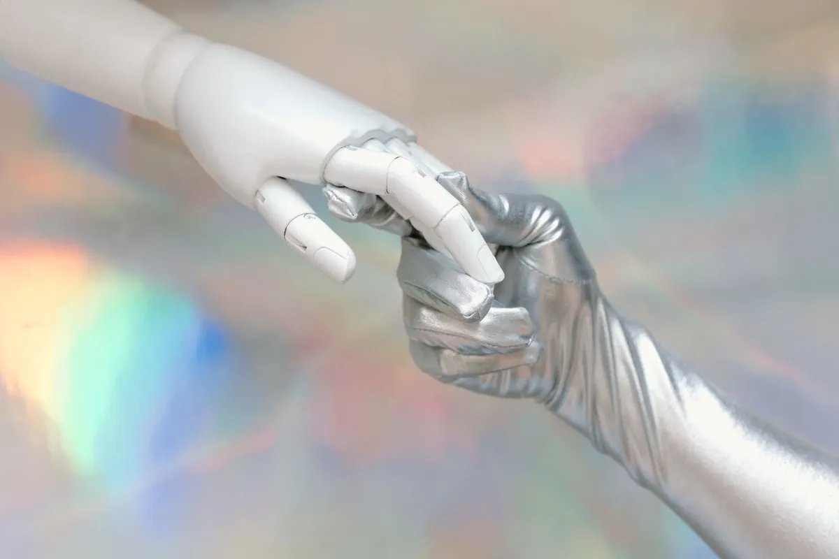 Human and robot hands meeting, representing AI agents at work