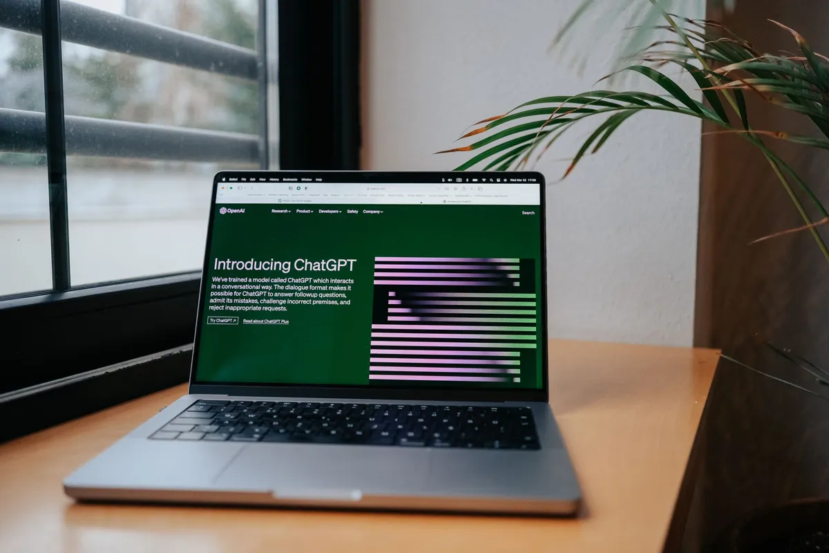 Laptop on a desk showing the ChatGPT introduction page