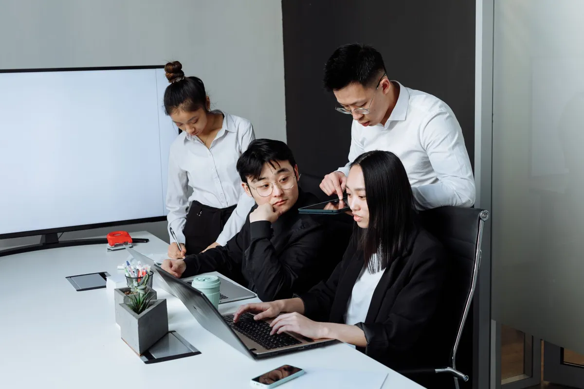 Team working through data together on a laptop
