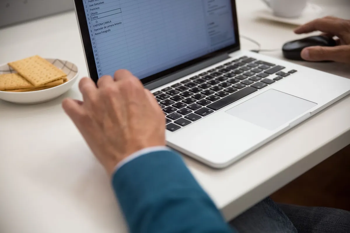 Office worker building a spreadsheet in Excel