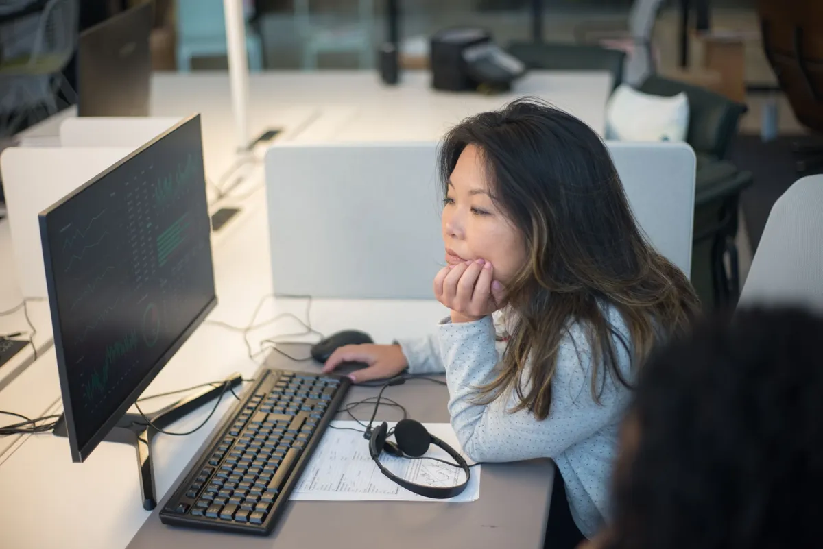 Office worker at a computer in an open-plan office