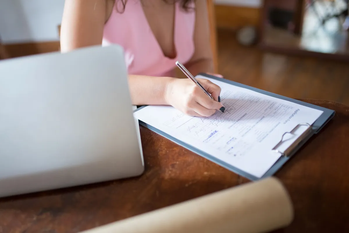 Office worker handling forms and approvals at a desk