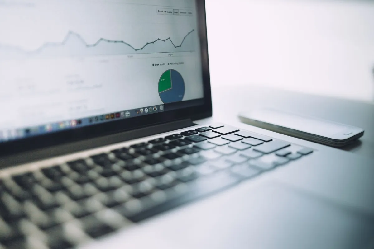 Laptop screen showing a line chart and pie chart report