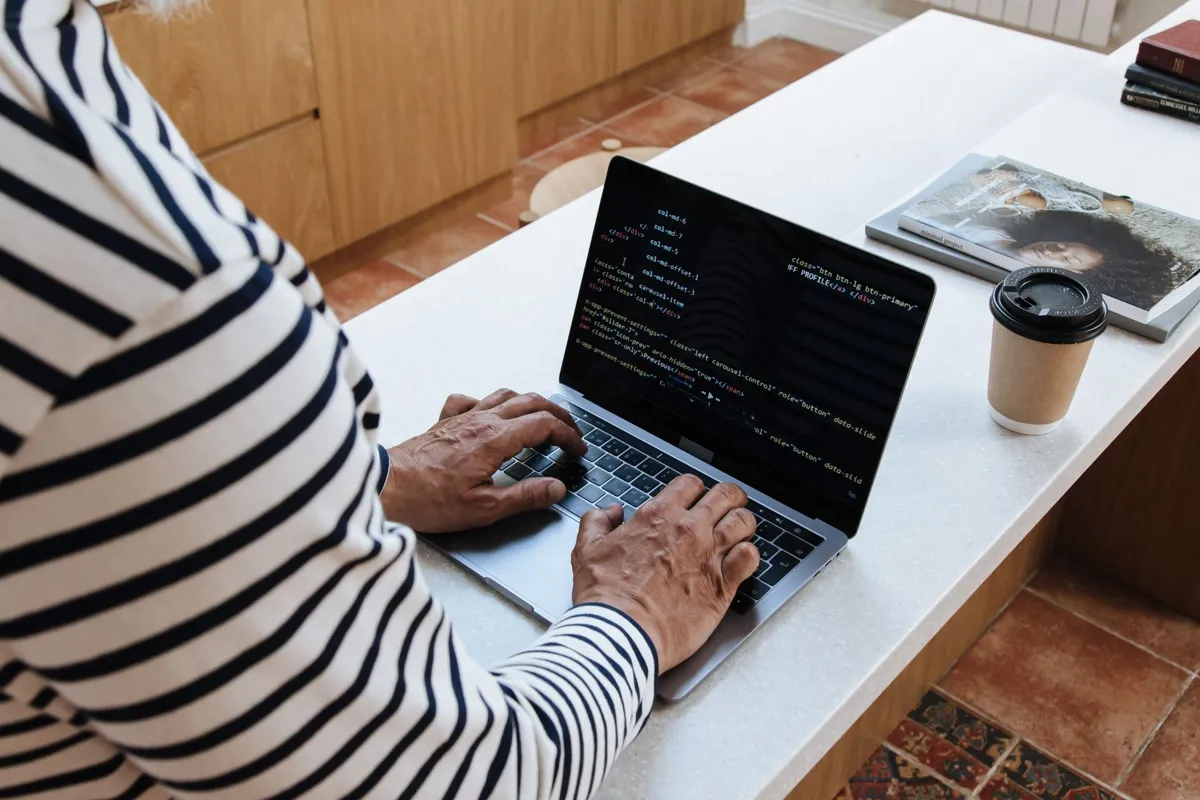 Adult learner practising programming on a laptop