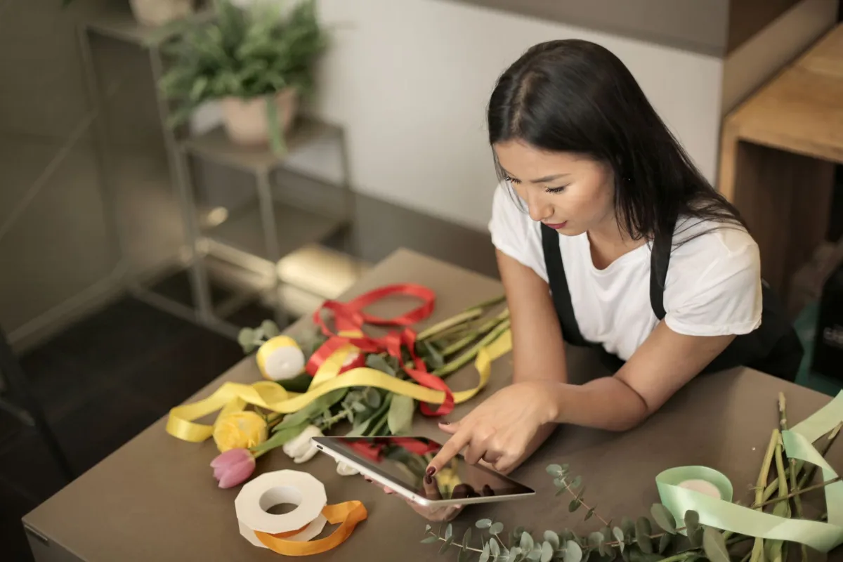 Florist running her small business on a tablet