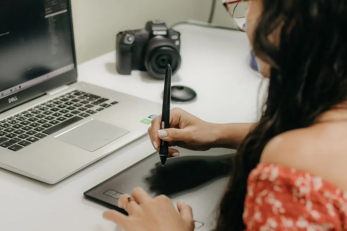 Person designing presentation slides on a laptop