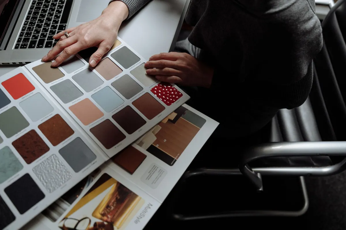 Designer browsing colour swatch samples at a desk