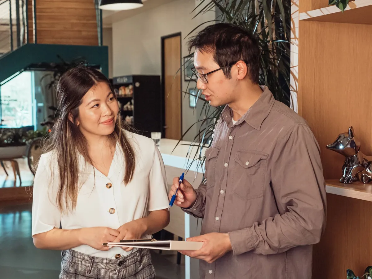 Two colleagues in conversation at work