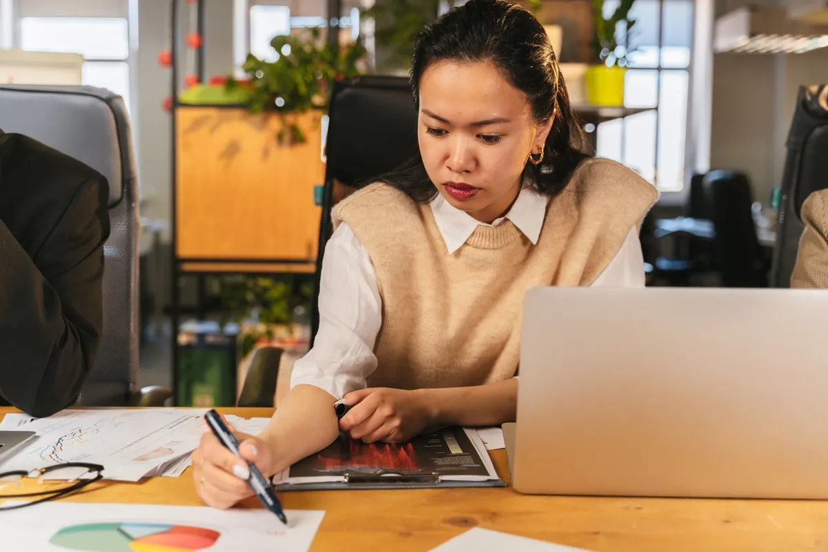 Office worker analysing data on a laptop