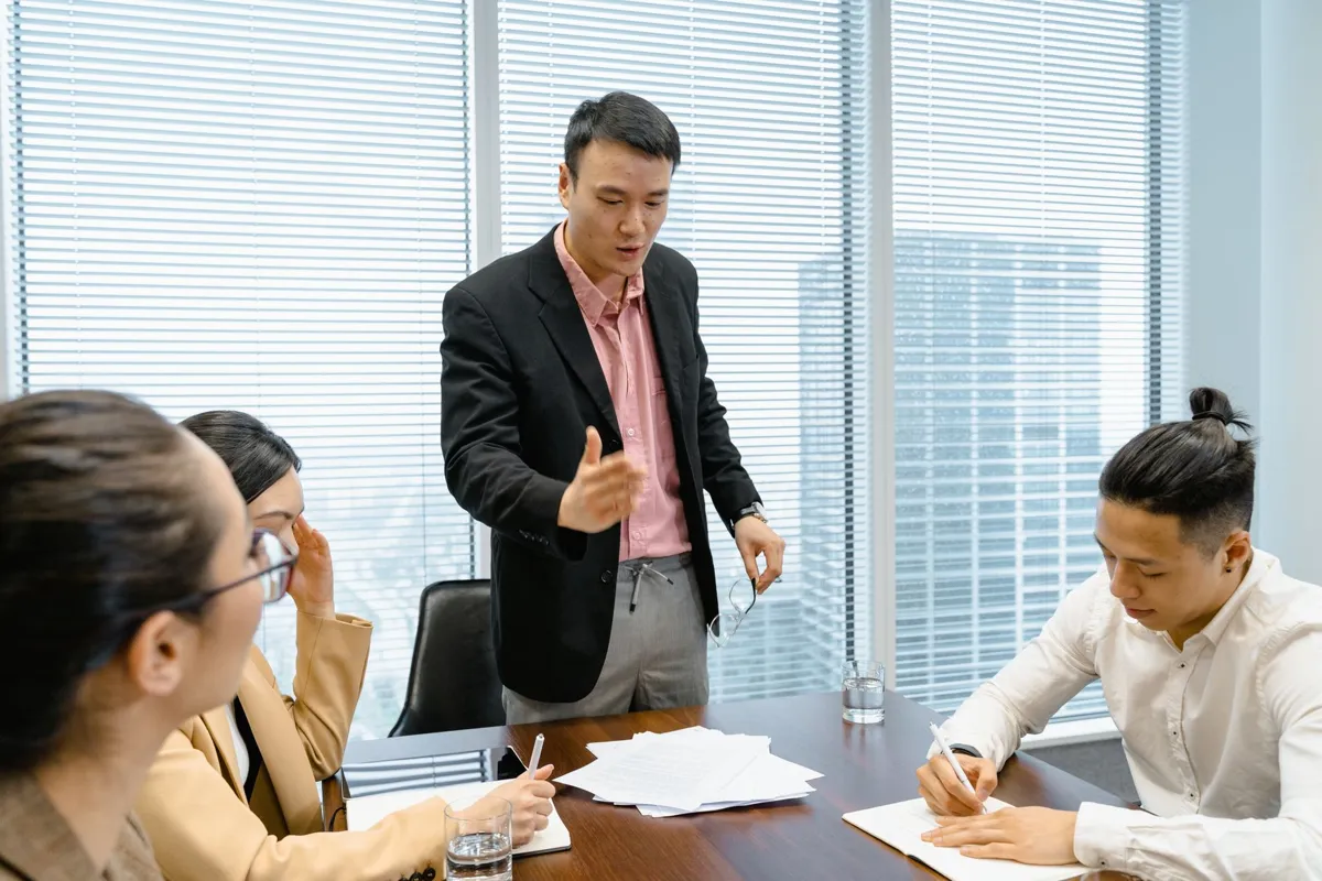 Trainer coaching a team around a meeting table