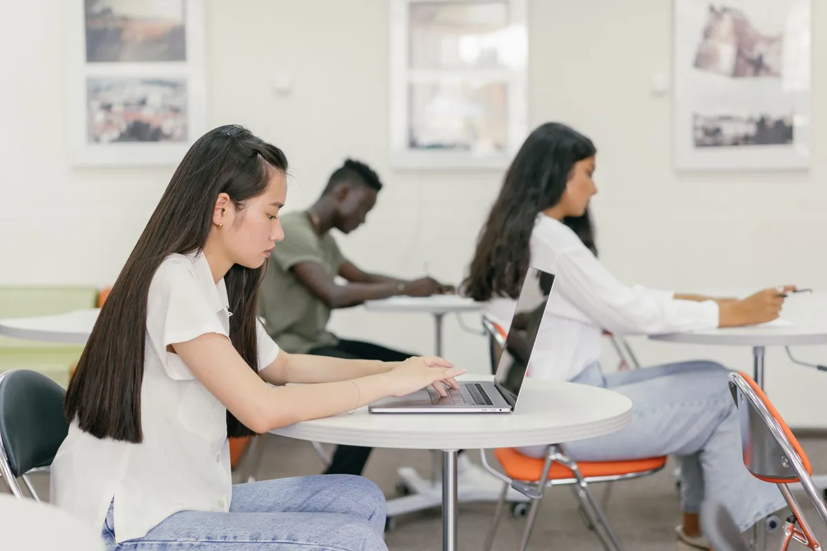 Adult learners at laptops in a training class